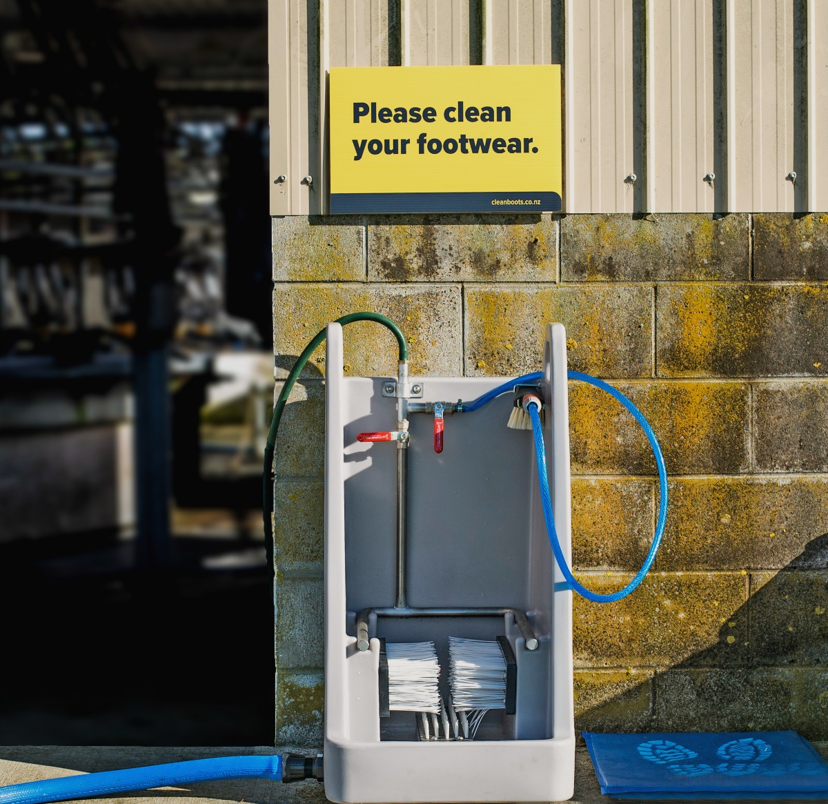 The PE bootcleaner and sign outside a cow shed